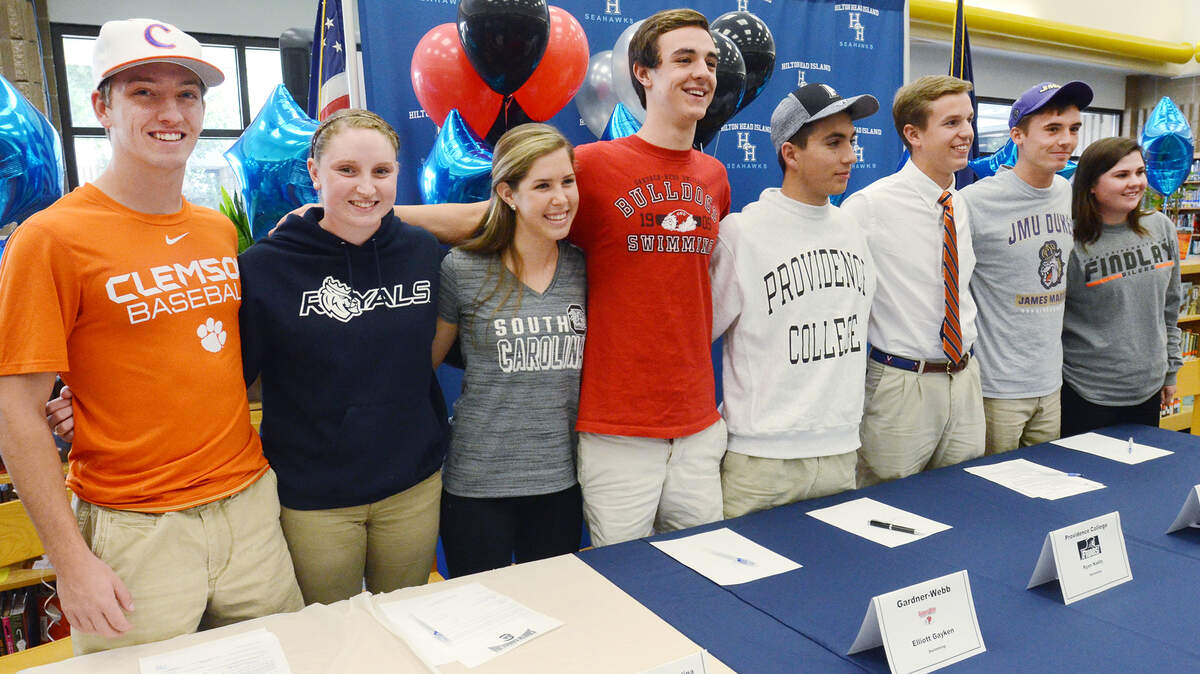 Hilton Head Island High School's fall collegiate scholarship signees pose for a group shot after Thursday's signing ceremony at the school. They are, from left, Mat Clark, Sarah Reamy, Hannah Edelman, Elliott Gayken, Ryan Naddy, Andrew Orischak, Tate Steinour and Meredith Wipper.