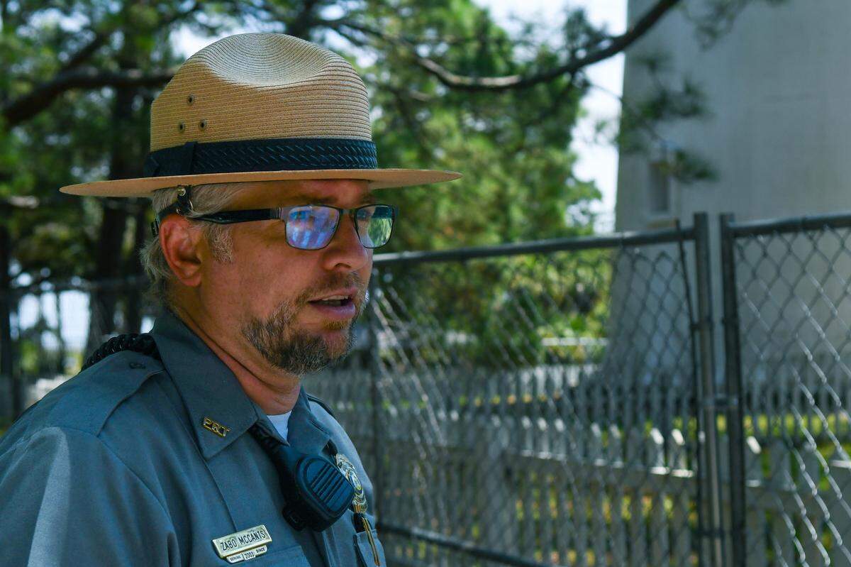 Surrounded by a chain link fence and closed to the public in February 2022, Thomas ‘Zabo’ McCants, manager for Hunting Island State Park, talks about the Hunting Island Lighthouse restoration efforts on Aug. 1, 2024 on Hunting Island.
