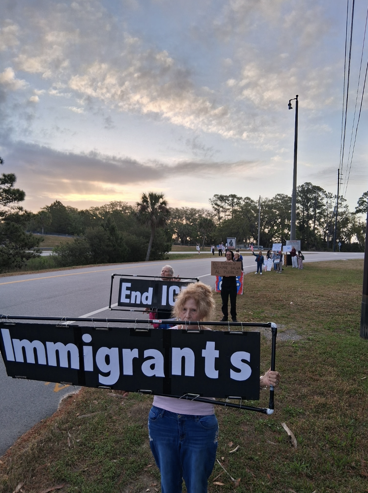 A group of protesters gathered on the off-ramp to Parris Island on the morning of April 3, 2026, opposing potential federal immigration enforcement efforts during graduation celebrations.
