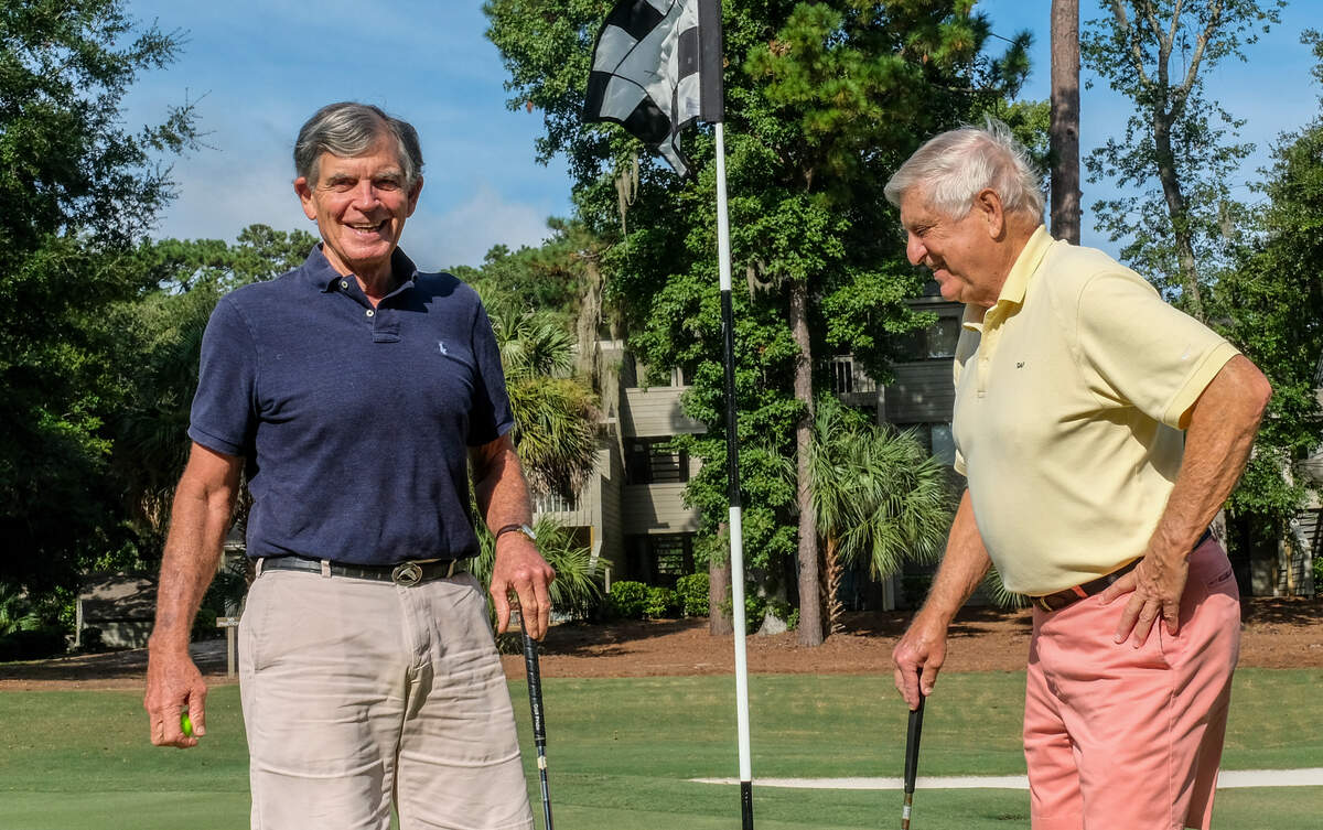 Ralph “Dupper” Dupps, left, and golf partner Don Furtado, right, joke around on the green of a Sea Pines golf course on Wednesday, Sept. 1, 2021, on Hilton Head Island. Dupps, a former pilot who is blind in his left eye and has macular degeneration in the other, recently made his first ace at a golf course in Hilton Head Plantation. Furtado, when asked if he’s ever made a hole-in-one, laughingly replied, “I’m lucky if I make it onto the green.”
