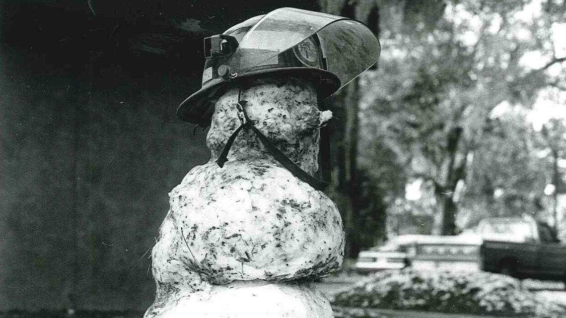 A snowman sits in front of a fire station with a helmet and boots on Dec. 24, 1989 on Hilton Head Island.