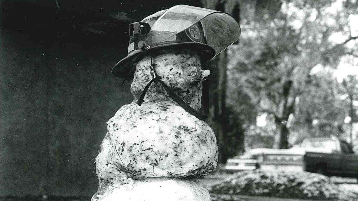 A snowman sits in front of a fire station with a helmet and boots on Dec. 24, 1989 on Hilton Head Island.