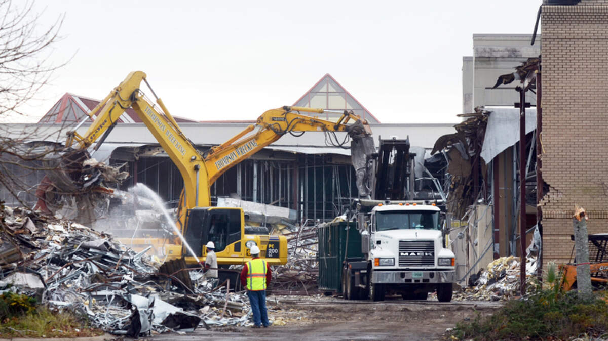 Demolition work has begun at the Mall at Shelter Cove. Here, excavators  take down the Off 5th Saks Fifth Avenue store on Thursday. Plans to  redevelop the 42-acre mall include a community park, a Kroger grocery  store, nearly 300,000 square feet of commercial space and more than 200  apartments.