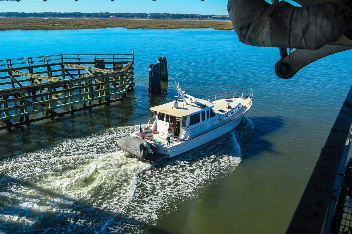 While not having to open the bridge to stop traffic, a boat makes its way under the Richard V. Woods Memorial Bridge on Nov. 29, 2022 on the Beaufort River, part of the Intracoastal Waterway. To keep vehicular traffic moving, the U.S. Coast Guard is recommending restricting opening the historic swing bridge from 6 a.m. to 9:29 a.m. and 3:31 p.m. to 7 p.m. Monday through Friday, except for emergencies.