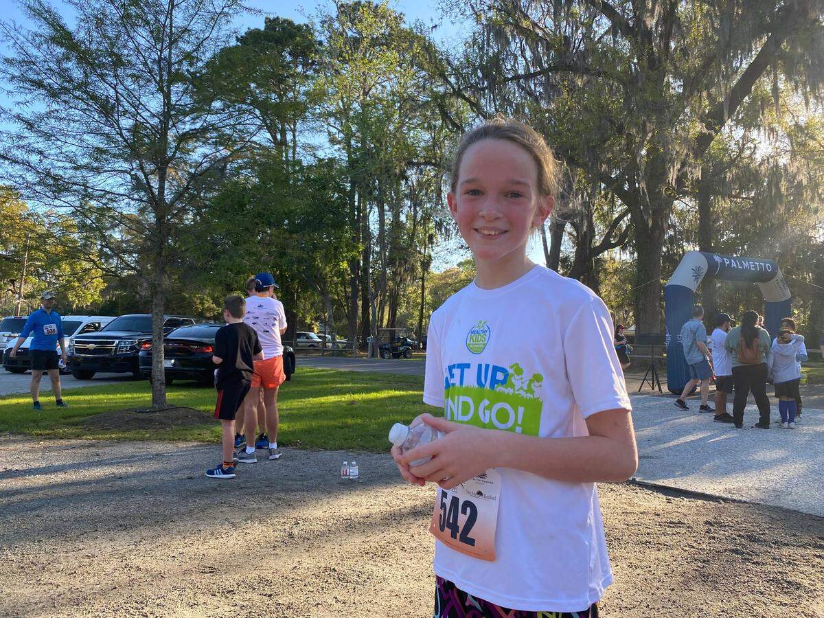 Keatyn Hammel-Millard, 10, is all smiles after her run at the Bluffton Lutzie 43 5K on Saturday.