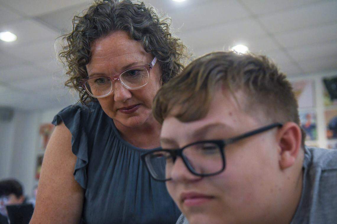 On the first day of class, Scarlett Mooney, left, director of BCSD Tides with the Beaufort County School District works with high school freshman Austin Abar on Aug. 6, 2025, to get logged onto the network for the dual enrollment program with Technical College of the Lowcountry at the New River Campus in Okatie. Students who enroll in the program experience college-level degree courses taught by TCL instructors.