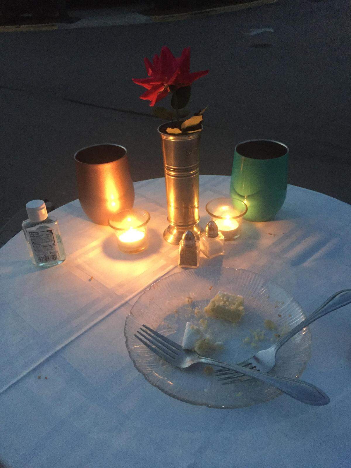 Walt Perkowski and Dionna Bauer’s social distance date night was equip with a tablecloth, napkins, a red flower and, of course, a small bottle of hand sanitizer.