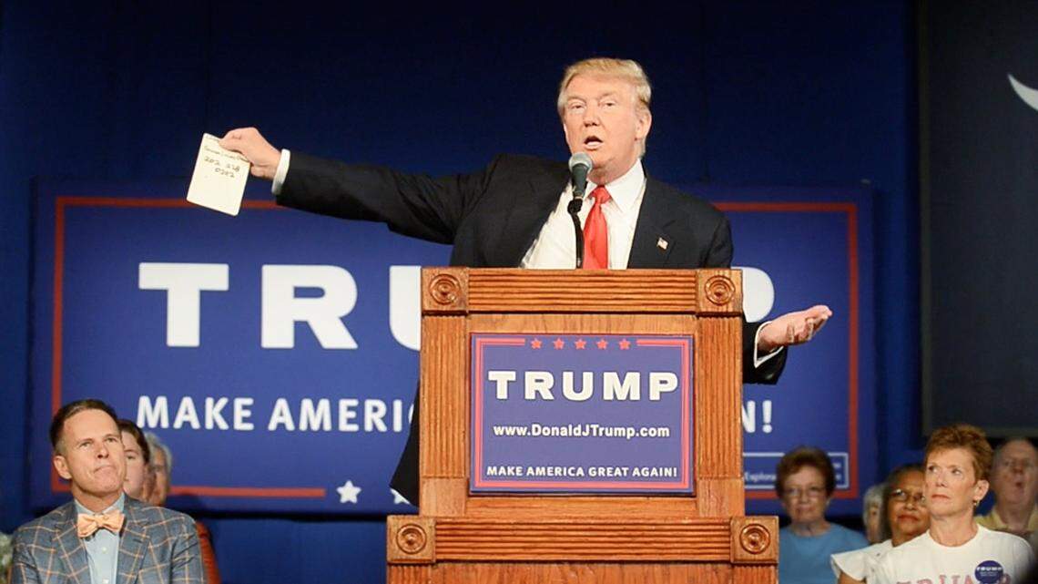 FILE PHOTO: Donald Trump holds a piece of paper with Sen. Lindsey Graham's phone number on it during Trump's appearance at Sun City Hilton Head.