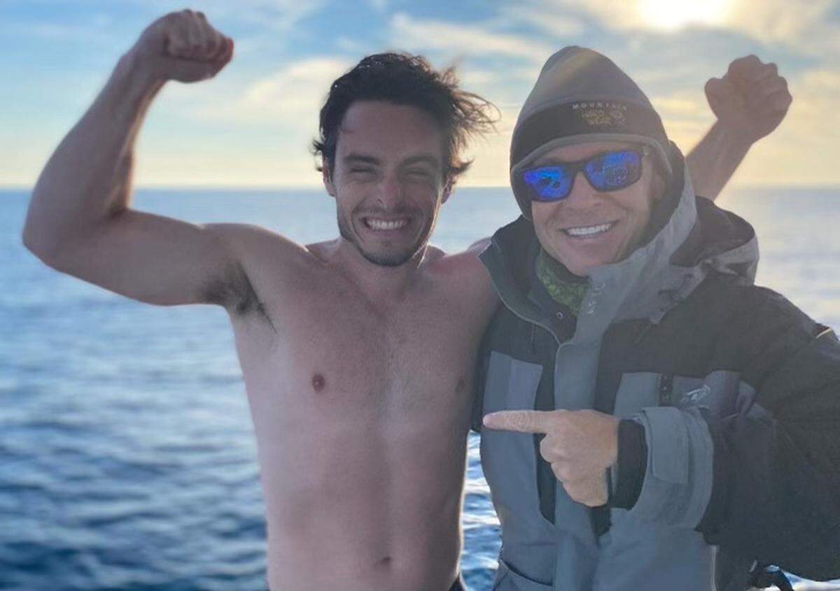 Ben Friedman, left, and Chip Michalove celebrate after successfully tagging a 10-foot, 8-inch great white shark off Hilton Head Island on Feb. 10, 2022. Friedman had to jump into the water to untangle the fishing line snagged on a barnacle on the boat’s hull.