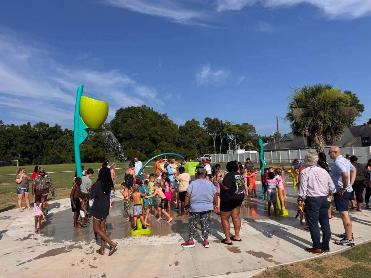 Kids and adults gather for the official opening of the splash pad at a Beaufort County park in Port Royal July 1.
