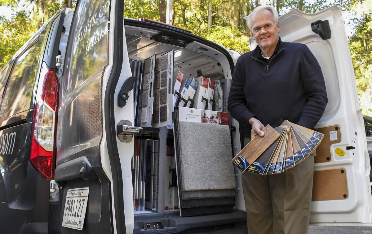 Scott Ramsland, with Floor Coverings International, is photographed on Tuesday displaying the flooring samples that utilize every nook and cranny of interior space in his minivan. Ramsland offers one-stop shopping for those looking to cover their floors, allowing customers to see samples in their home rather than at a store.