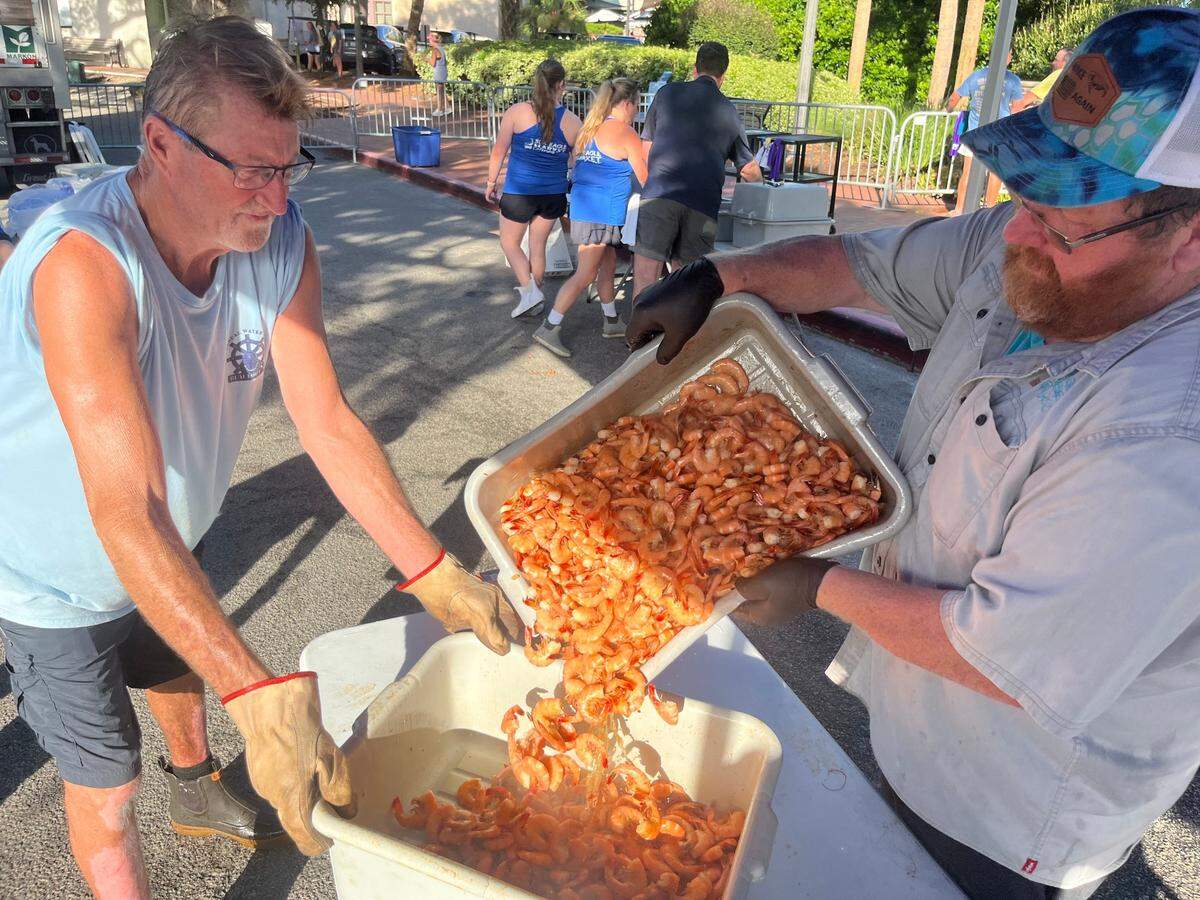 Cuda DeLoach and Craig Reaves prepare locally-caught shrimp during the Lowcountry Supper during the Beaufort Water Festival Thursday.