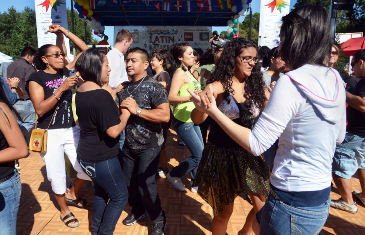Dancers fill the floor during The Latin Music Festival held on Sunday at Shelter Cove Community Park on Hilton Head Island. The event, held as a part of Hispanic Heritage Month, featured four Latin bands and a DJ; salsa lessons by professional instructors; a NASCAR simulator; children's entertainment; and over 65 vendors of food, arts and crafts.
