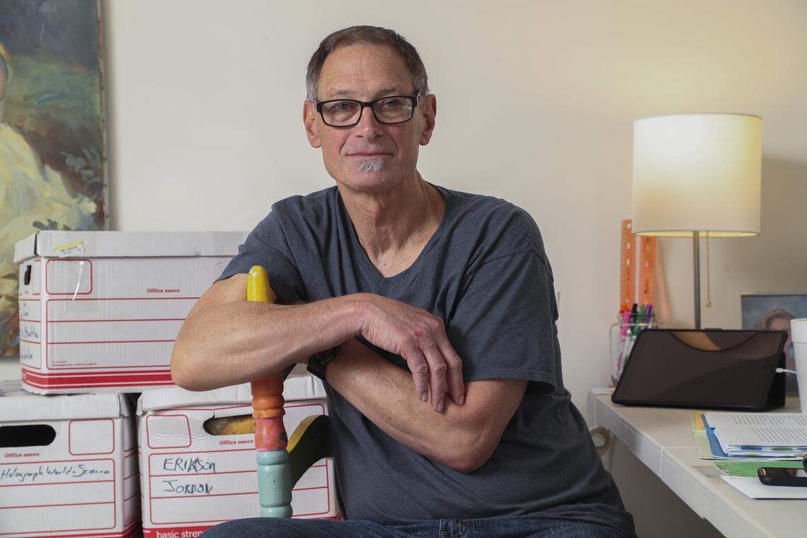 Drew Mills Dobson sits for a portrait in his office in March soon after his release from prison. Pictured behind Dobson are boxes of his manuscripts that he wrote while serving his time in prison for robbing five banks over a 10-month period in the 1980s.