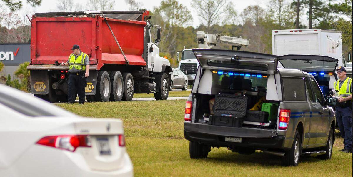 Investigators with the S.C. Highway Patrol’s Multi-disciplinary Accident Investigation Team shoot video, left, as the other, right, flies a drone on Tuesday, March 22, 2022 at the site of a hit-and-run from the night before. A pedestrian was killed in the accident, which happened at U.S. 278 and Okatie Center Boulevard South near Sun City Hilton Head.
