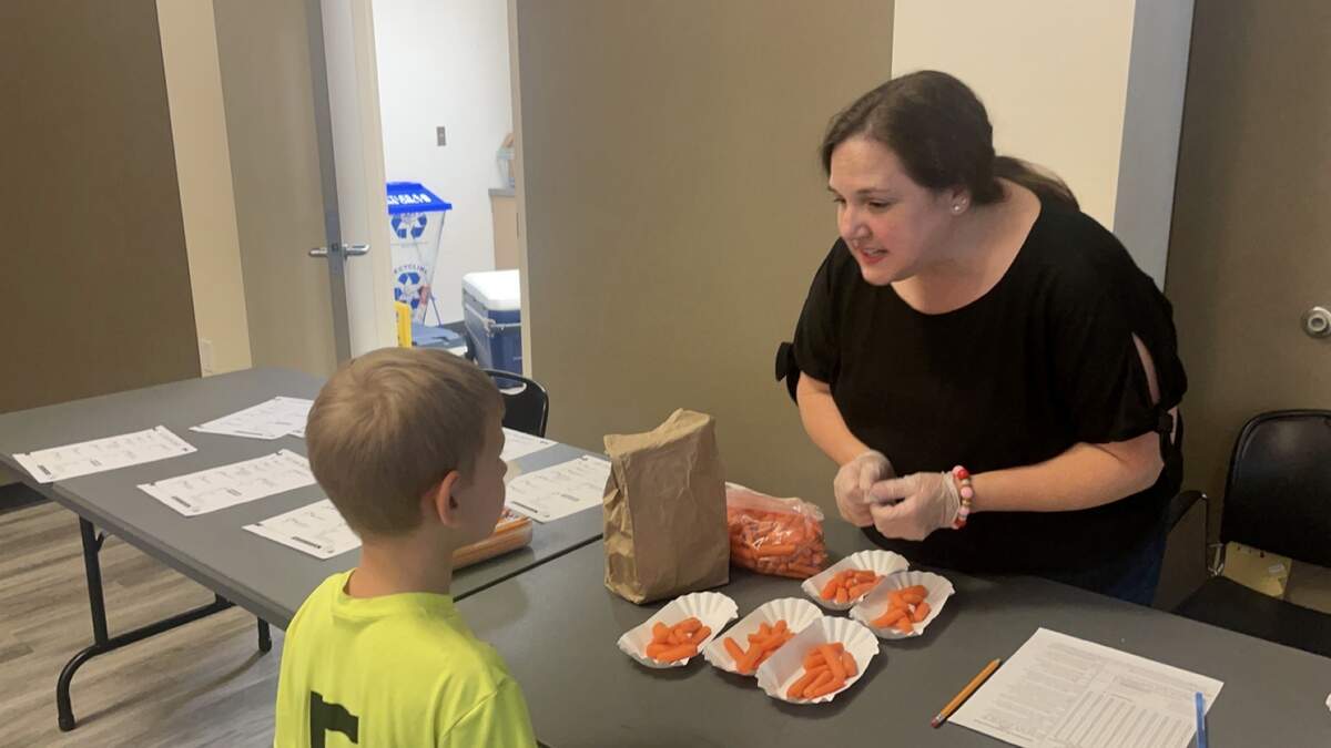 Free lunches for kids are available at all Beaufort County Library branches this summer from Monday through Friday until August 4. Here, Melinda Vest helps hand out healthy lunches on Friday, June 9 at the Bluffton Branch Library.