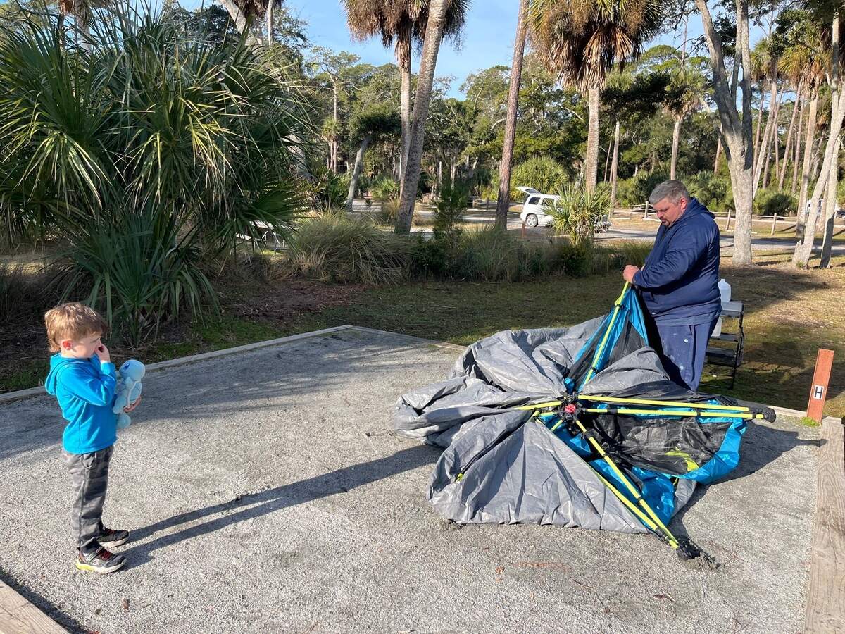 Matt Tadlock of Bluffton breaks down his tent while his son, Caleb, 4, watches. Tadlock said there was frost on his tent when he woke up Wednesday morning.