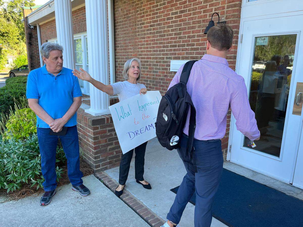 Tricia Fidrych addresses Scheaffer Watt, a project manager for Watt Inc., the construction management company working for Safe Harbor Marinas, as he arrives at a Town Council meeting at Port Royal Town Hall Thursday. Residents were protesting because they are not happy with Safe Harbor’s development plans for the town’s water front.