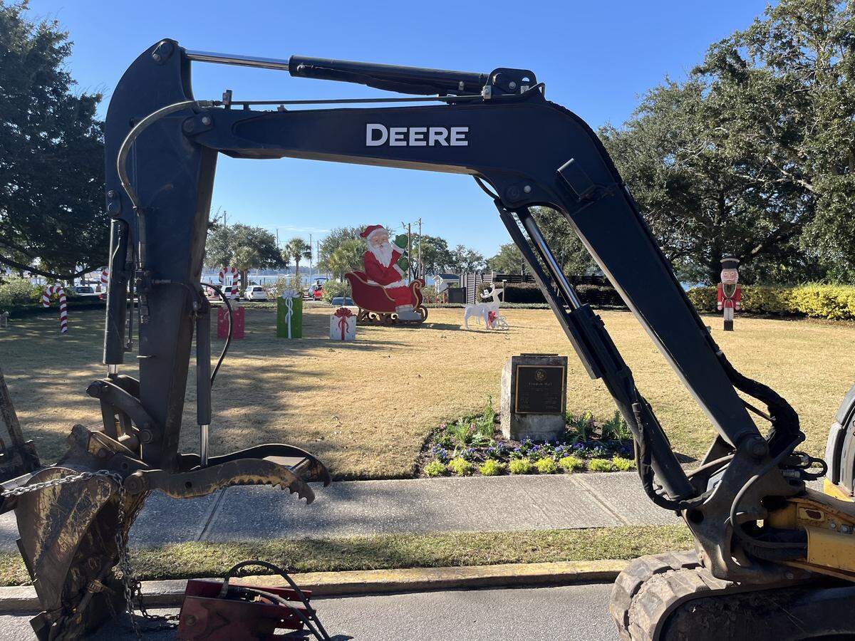 Construction equipment frames the holiday decorations in downtown Beaufort, where a major stormwater drainage project has closed a key intersection as the holidays approach, frustrating downtown businesses. Downtown Beaufort, however, remains open for business.