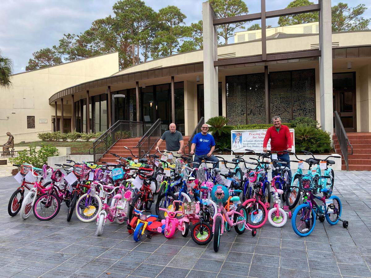 Frank Sheridan, Lupe Jimenez and Joe Mendon stand with the bikes they readied for delivery to children on Hilton Head Island as an early Christmas gift.