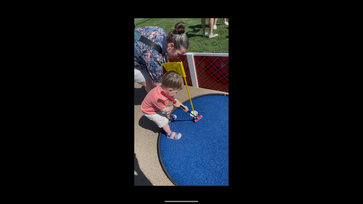 Two-year-old Finn from New Jersey struggles to hold a putter, but appeared to still be having fun at the kid’s mini golf station at RBC Heritage.