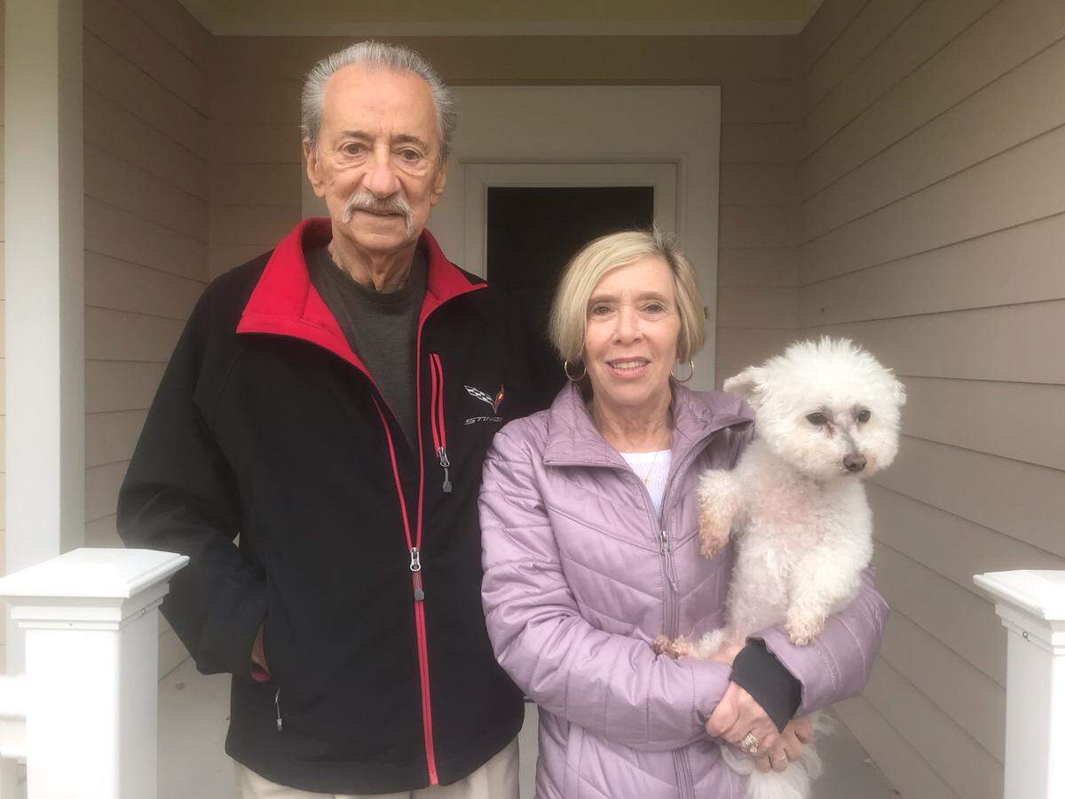 Robert and Dale Susan Terwilliger stand on the front porch with their dog Bailey, Thursday morning at their Sun City Hilton Head home.  The couple may receive money from a class-action lawsuit after spending about $48,000 to repair themselves for stucco-related problems on their home.