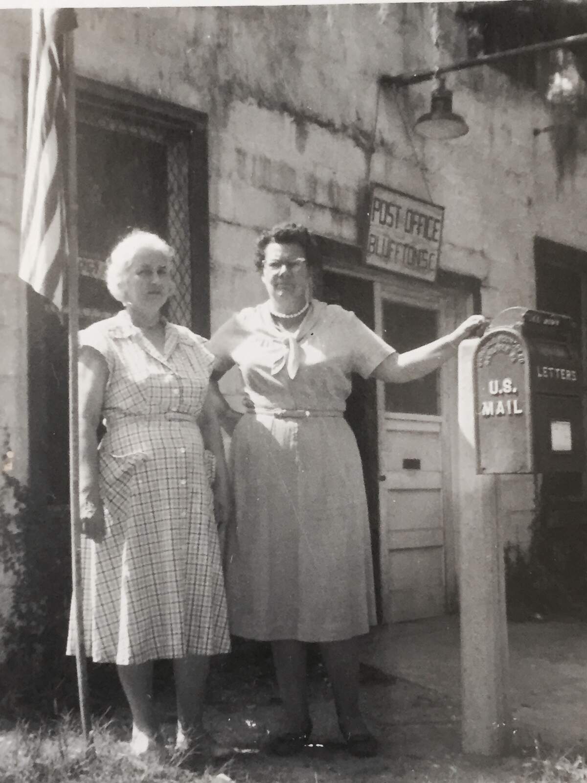 Lucille Heyward (left) and an unknown woman pose in front of the Bridge Street, Bluffton, South Carolina, building commonly known as “The Rate.” The building began as an ice cream shop and convenience-style store, but later became Bluffton’s post office. Heyward served for a time as the post mistress.