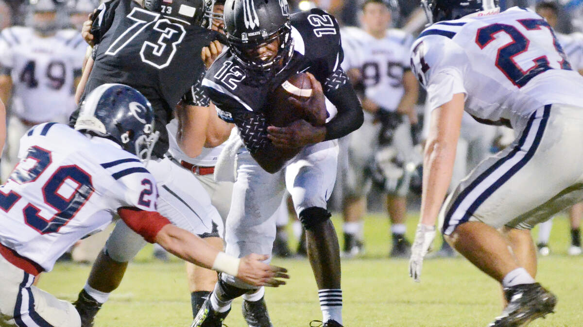 Bluffton quarterback Terrance Heyward gains some hard yardage on a quarterback keeper during the Aug. 28 game with the Effingham County (Ga.) Rebels.