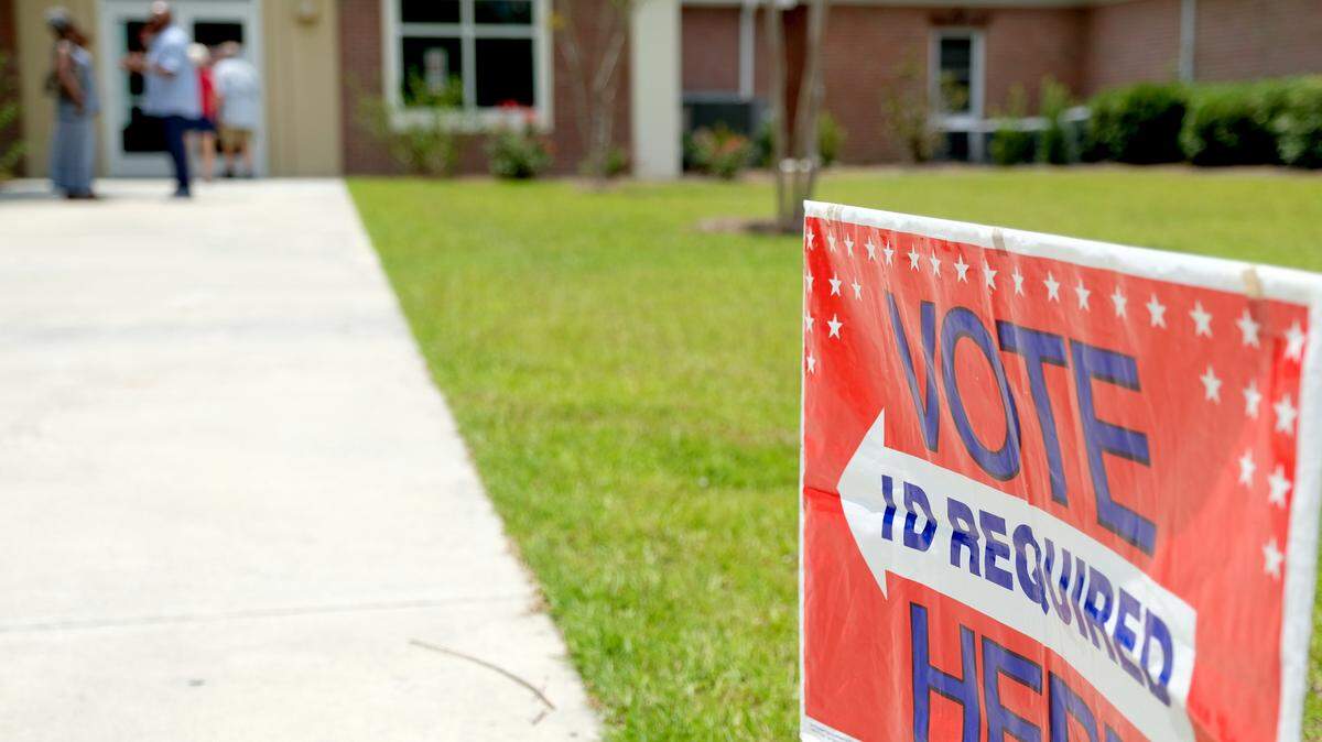 Voters congregate outside Community Bible Church on Tuesday on primary election day. Burton Districts 2A and 2B were at the church and poll manger Aremethia Burnes estimated at 1 p.m. they had about 250  votes cast. 