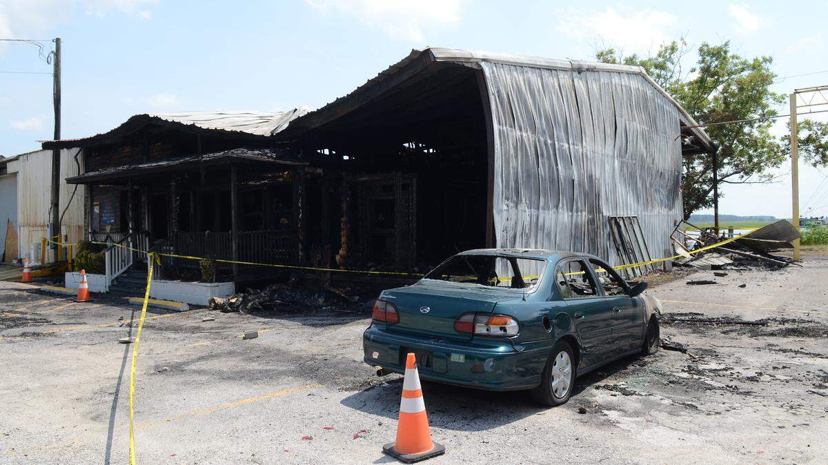 Photographed July 20, 2015, an empty burnt-out shell is all that remains of the Port Royal seafood market. Investigators have ruled out arson as the cause of the fire that ripped through the building July 19 and forced one of the area's most popular restaurants, 11th Street Dockside, to close indefinitely. The fire started in the market and grew between the first and second floors in the market's back corner, Beaufort-Port Royal Fire Department Capt. John Robinson said. 