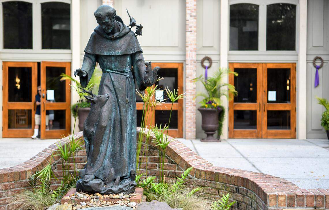 Visitors leave St. Francis By The Sea Catholic Church on Friday, March 13, 2020 on Hilton Head Island with signs posted at every entrance informing congregants that flu season has arrived. The church asked that they not shake hands and to receive communion “on the hand.” In a press release, the Roman Catholic Diocese of Charleston informed those who wish to stay home from Mass due the COVID-19 pandemic, that they could watch Mass online posted by churches in Greenville and Garden City.