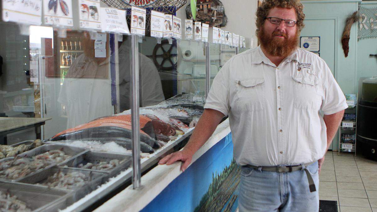 Sea Eagle Market owner Craig Reaves stands for a portrait in the front of the store on Tuesday afternoon on Boundary Street in Beaufort.