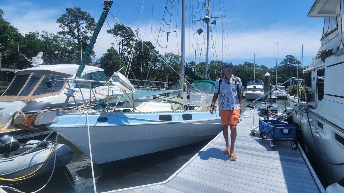 Robert (Roby) Breger walks along the dock on Hilton Head Island. Breger juggles a suite of side hustles, both on and off the water, to balance his finances and find personal freedom.