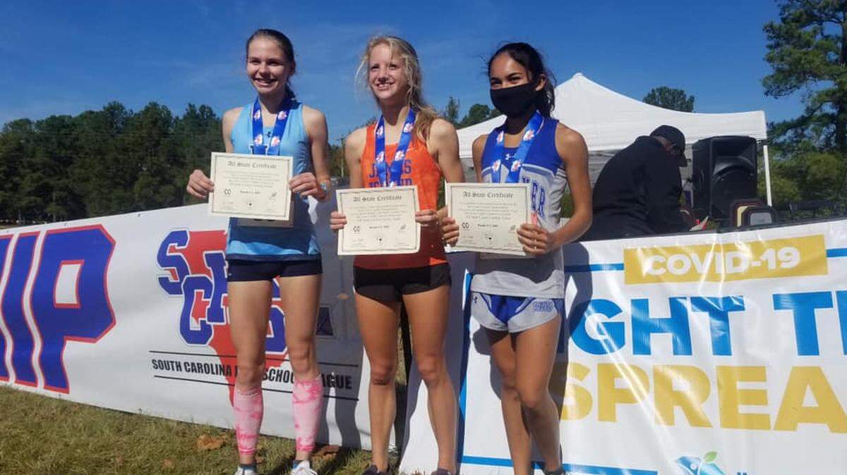 May River’s Anya Arroyo, right, finished second and Hilton Head Island’s Cynthia Gudaitis, left, finished third at Class 4A girls country championships on Thursday. James Island’s Hannah Vroon, middle, won the race.