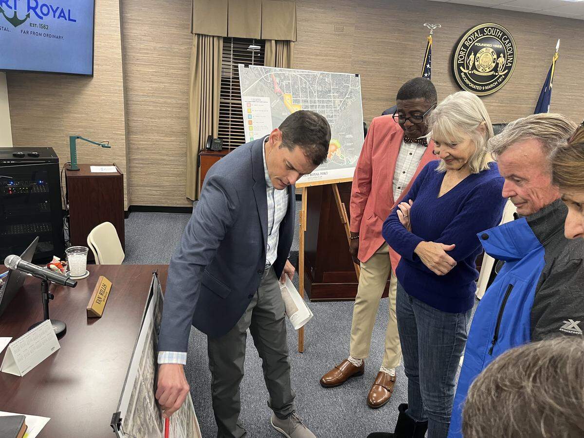 Dan Keefer, a land planner with Witmer, Jones and Keefer of Bluffton, explains Safe Harbor Marinas plans for waterfront redevelopment to residents and Town Councilman Darryl Owens, left, on Dec. 10 in the Port Royal Town Council chambers.