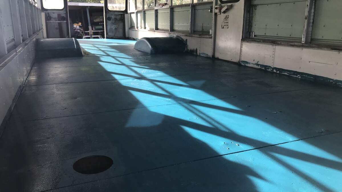 We needed to paint the metal floor to prevent future rusting. Since we’ve always wondered how teal walls would look in the bus, we decided to try the color (Tsunami by Behr) on a layer of the floor that will be hidden under insulation and subfloor.