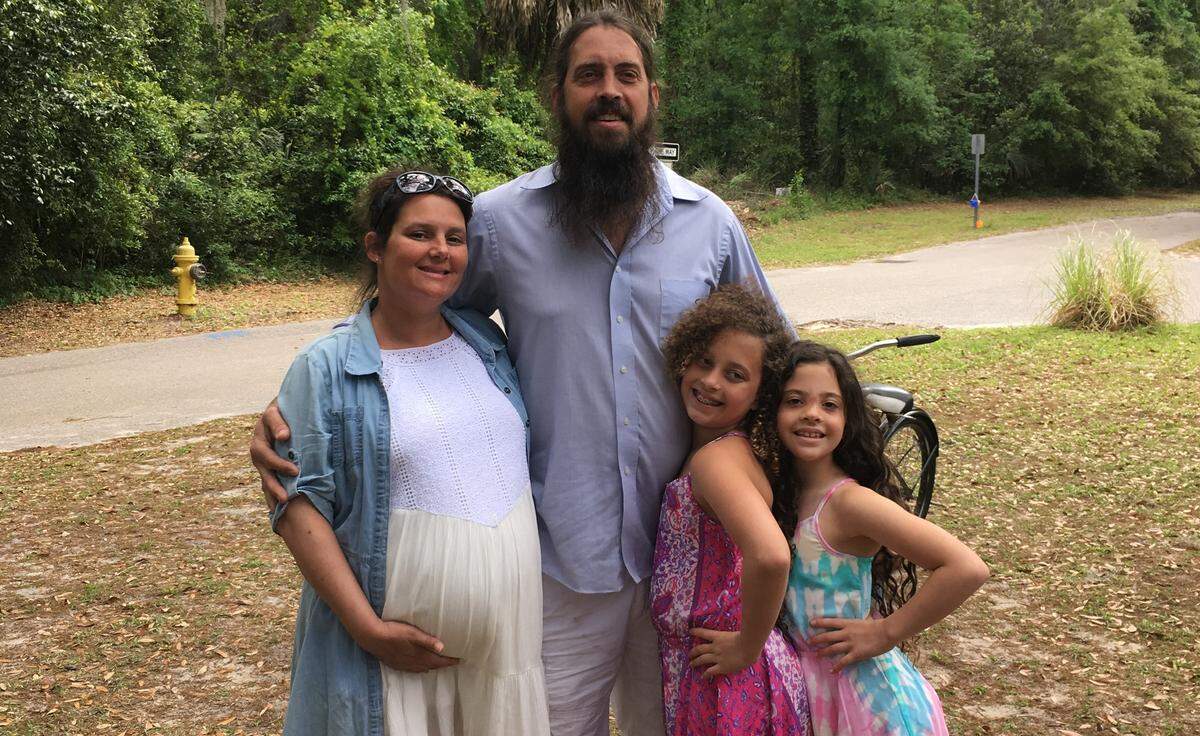 Cassie Byam and Jason Cooke are photographed with Jason’s daughters Carynn and Farah. They also have a third daughter, Bella, and are expecting a son in June.
