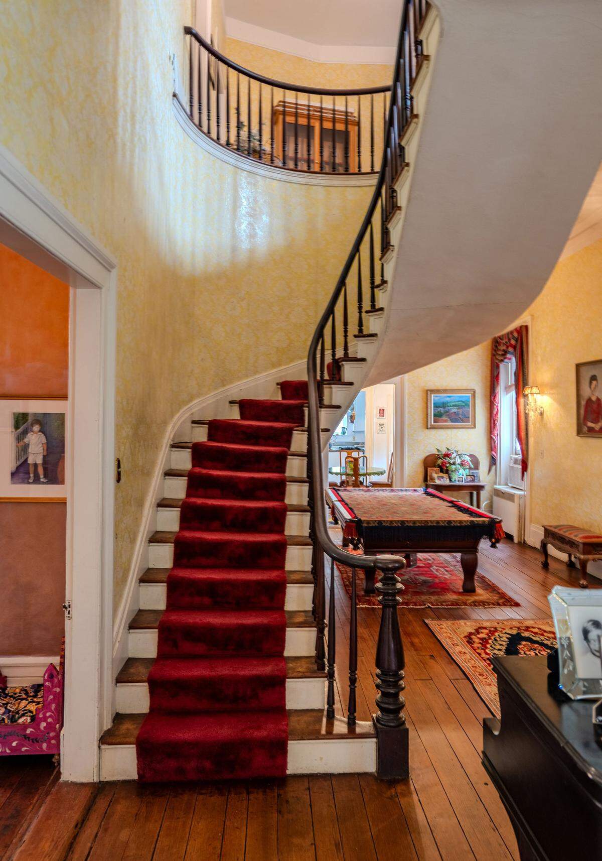 The home welcomes visitors into a grand entrance hall, where a floating staircase immediately draws the eye.