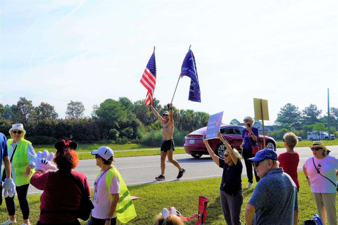 A supposed counterprotester, touting large American and Trump 2024 flags as he jogged past demonstrators, was largely ignored by the crowd. Attendees elected not to chant during the Friday morning protest of Ron DeSantis’ campaign visit to Bluffton.