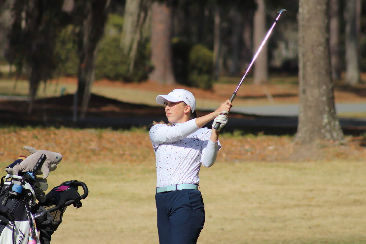 Golfer hitting with an iron
