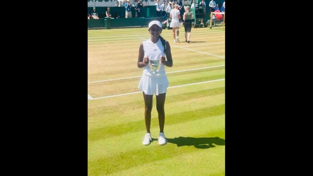 Isha Manchala holds her trophy Sunday morning after winning the Wimbledon girls’ under 14 championship.