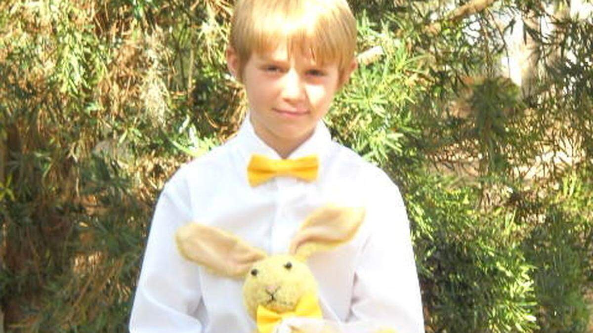 Ring bearer Jack Ghirardelli holds the special family rabbit that helped him carry out his duties.