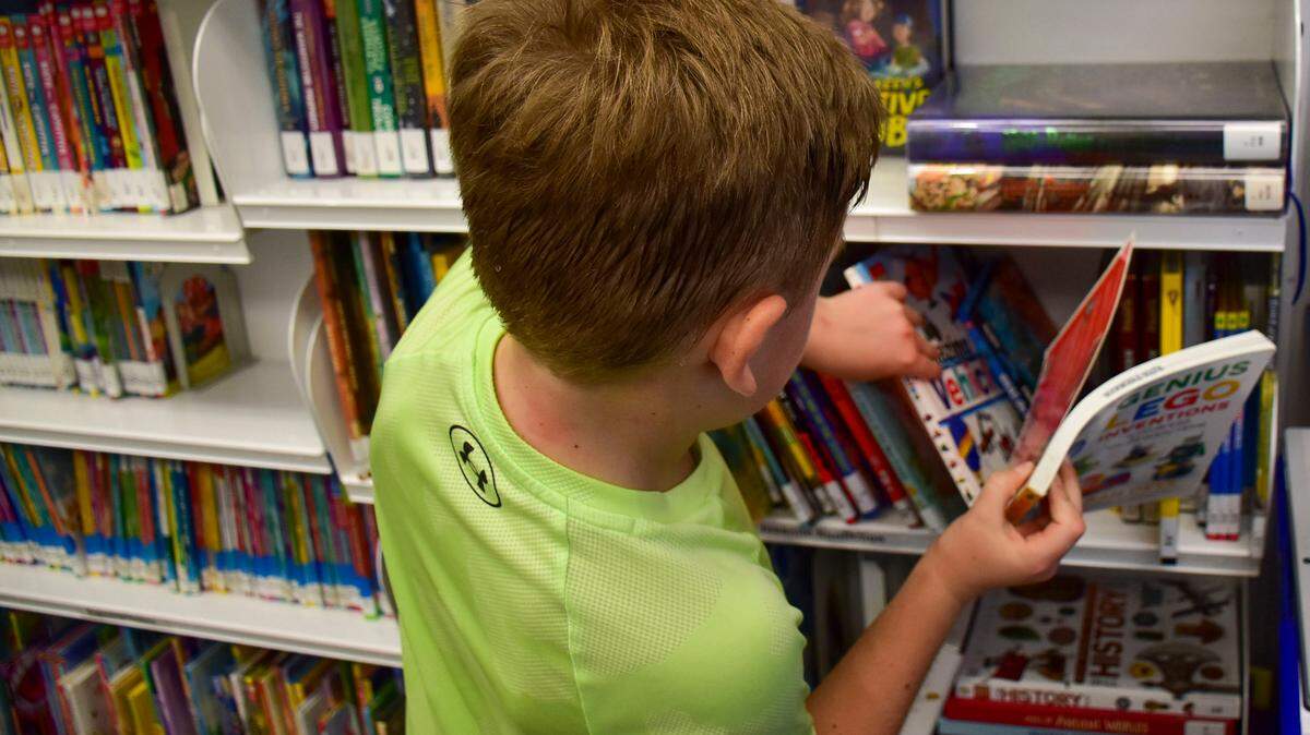 A student checks out some of the 2,500 books available from the Beaufort County Library bookmobile.