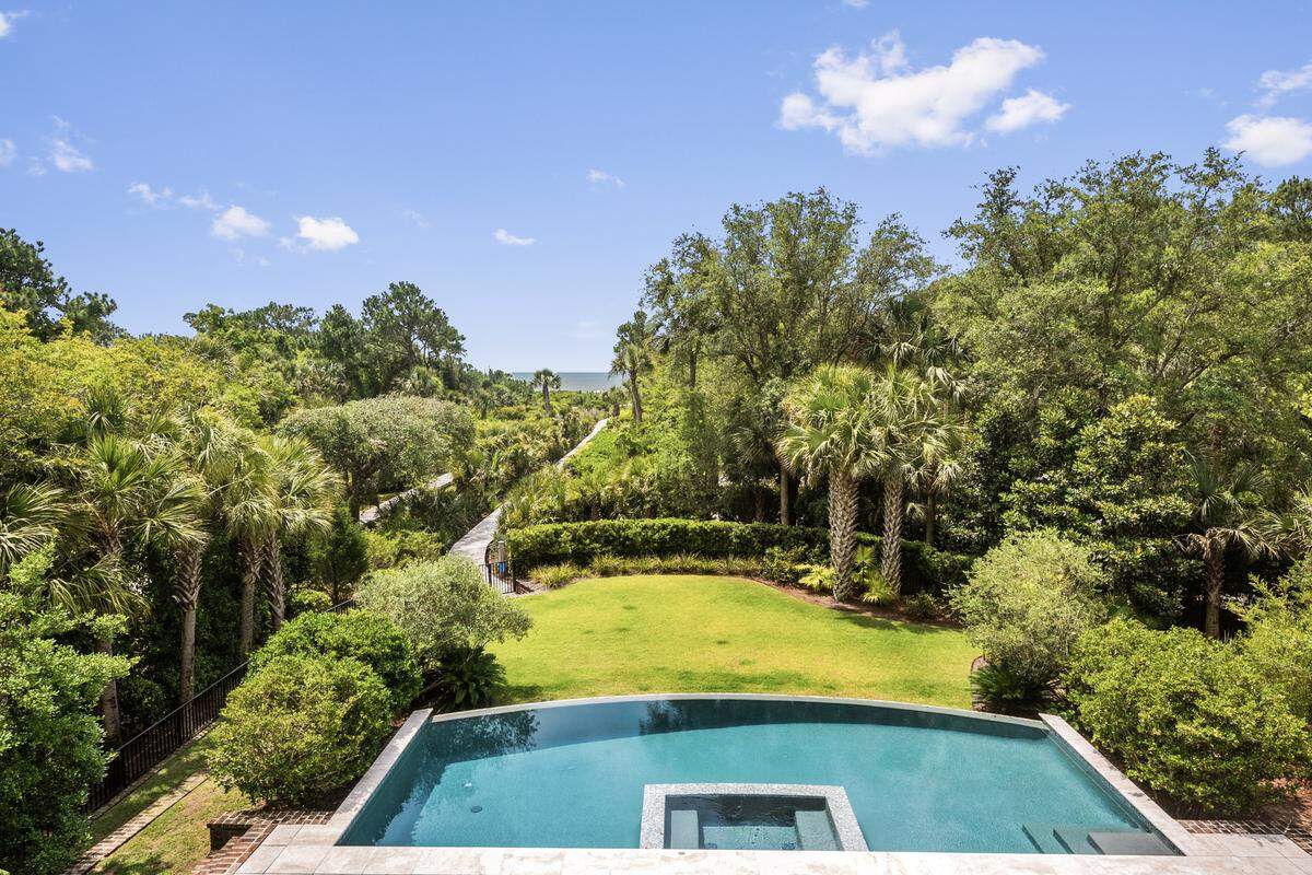 The heated saltwater infinity pool and spa is accompanied by a private boardwalk to Osprey Beach on Kiawah Island. The $20.8M property is located at 101 Flyway Drive.