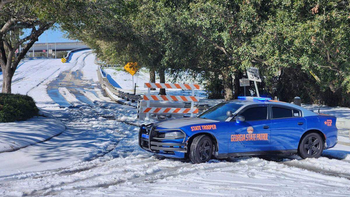 A Georgia state trooper vehicle blocks the entrance to the Talmadge Memorial Bridge leading to South Carolina the morning of Jan. 22, 2025. The bridge closed due to wintry conditions and at least one disabled vehicle that blocked lanes on the nearly 2-mile span crossing the Savannah River.