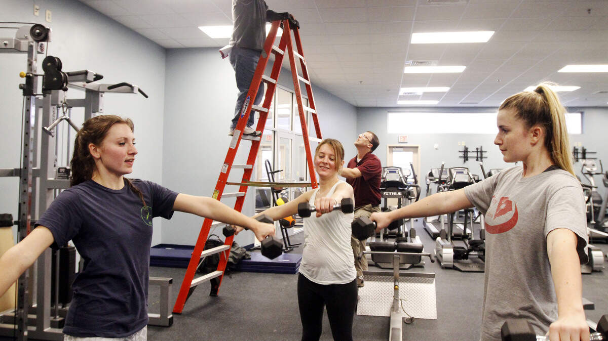 USCB freshman Krystal Maldonis, Madison Ethridge and Naomi Wadsworth lift dumbbells at the new recreation center at the University of South Carolina Hilton Head Gateway campus on Jan. 12, 2015.
