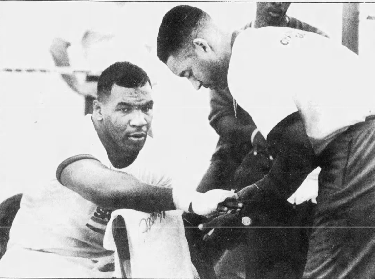 Mike Tyson, wearing longjohns, gets his hands wrapped before working out at a tent near the old Hyatt Regency on Hilton Head on June 7, 1989.