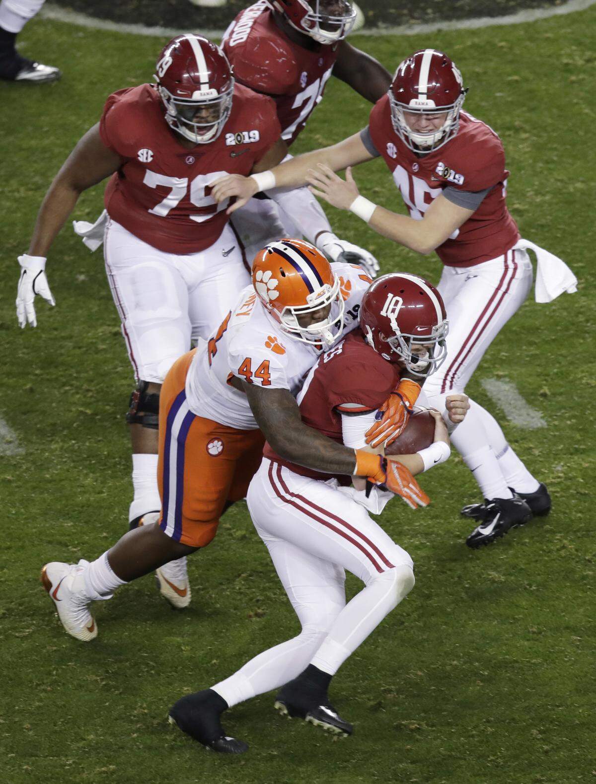 Clemson’s Nyles Pinckney stops Alabama’s Mac Jones on a fake field goal attempt during the second half of the NCAA college football playoff championship game, Monday, Jan. 7, 2019, in Santa Clara, Calif.