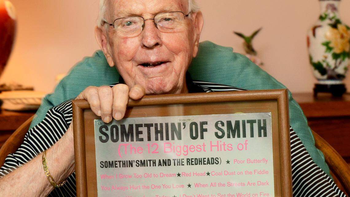Major Short, bassist of the musical group Somethin' Smith and the Redheads, is photographed holding one of the group's album covers on Tuesday. The group helped popularize the banjo in popular music, and, as lone surviving member, Smith is about to be inducted into the Banjo Hall of Fame.