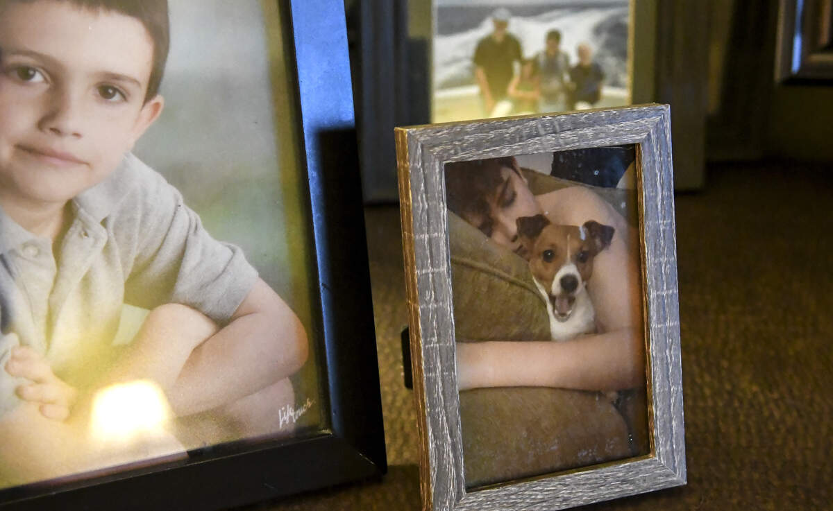 A photo among a host of other family shows Cotesworth “Cotesy” Daniel Arrieta as he sleeps with his dog, Minnie. Cotesy took his own life Tuesday morning at the age of 16. The family brought armfuls of family photos from their home to a condominium because they couldn’t bear to stay at the home where Cotesy died.